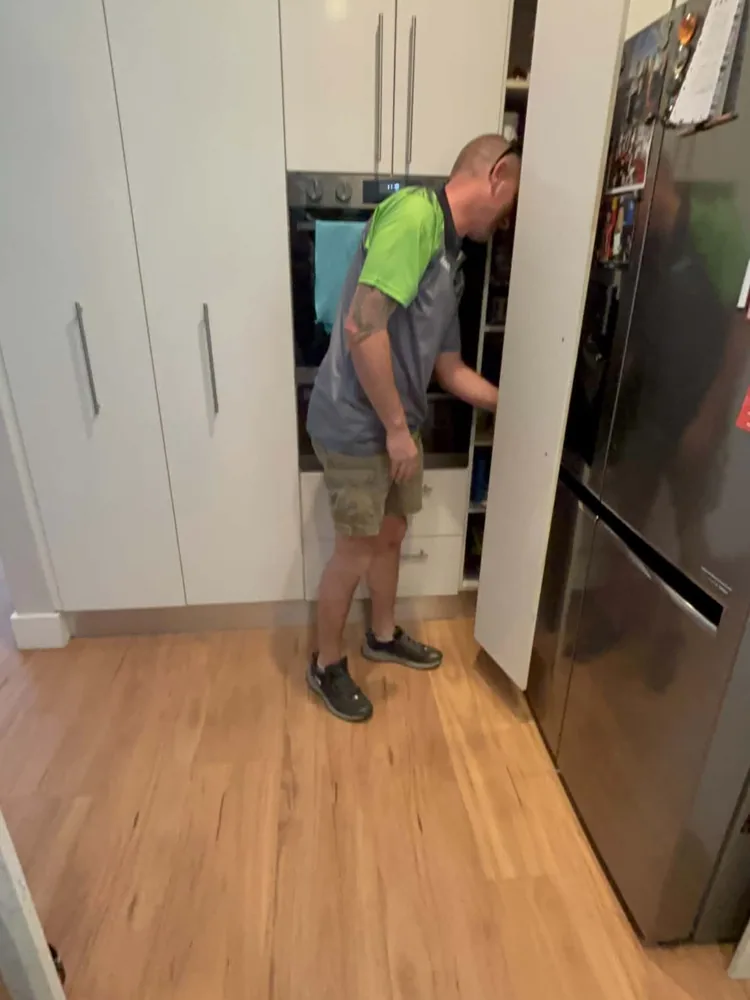 Wayne checking a kitchen pantry for pests